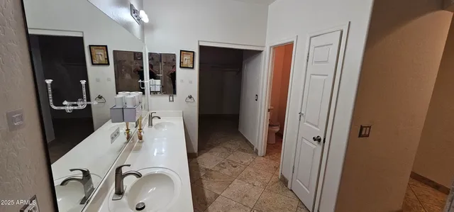 a room with stainless steel appliances a refrigerator and cabinets