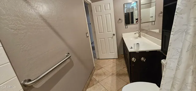 a bathroom with double vanity and a toilet