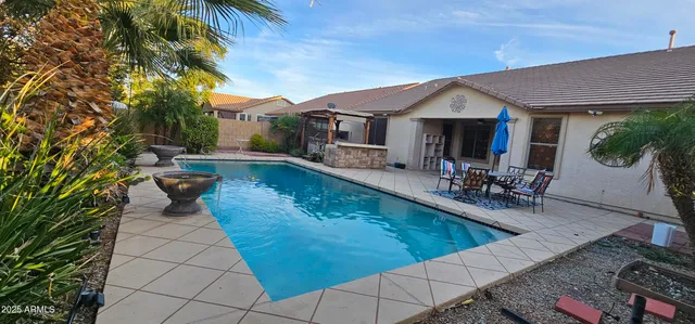 a view of a patio with chairs and potted plants