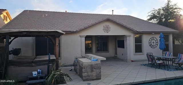 a backyard of a house with outdoor seating