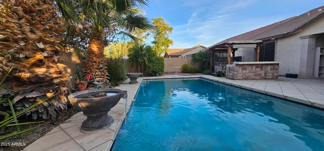 a view of a patio with chairs and plants