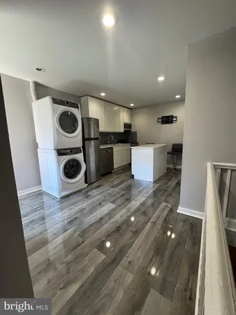 a view of kitchen and sink with wooden floor