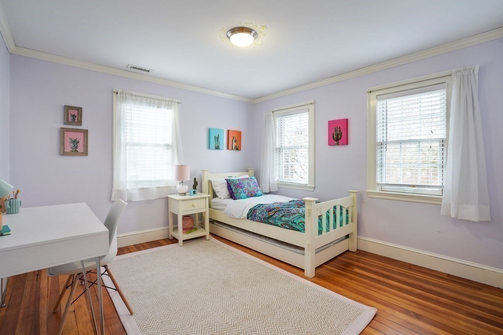 19 Vine Brook Road Lexington, MA 02421 - Photo 13 of 19 a bedroom with a bed and a table in it with window