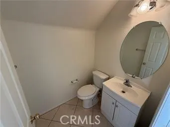 a bathroom with a sink toilet and a mirror