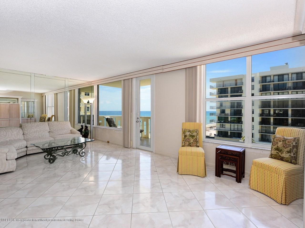 a living room with furniture and large windows