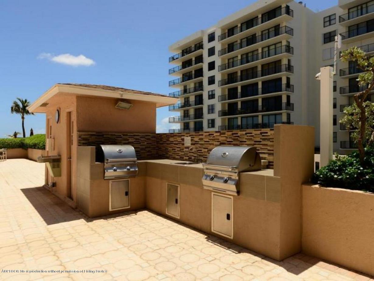 3450 South Ocean Boulevard, Unit 410 Palm Beach, FL 33480 - Photo 19 of 21 a kitchen with stainless steel appliances kitchen island granite countertop a sink and cabinets