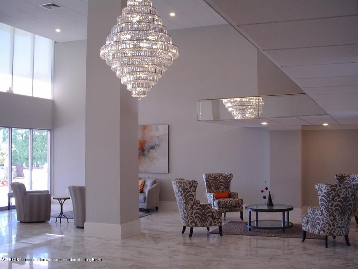 3450 South Ocean Boulevard, Unit 410 Palm Beach, FL 33480 - Photo 21 of 21 a living room with furniture and a chandelier
