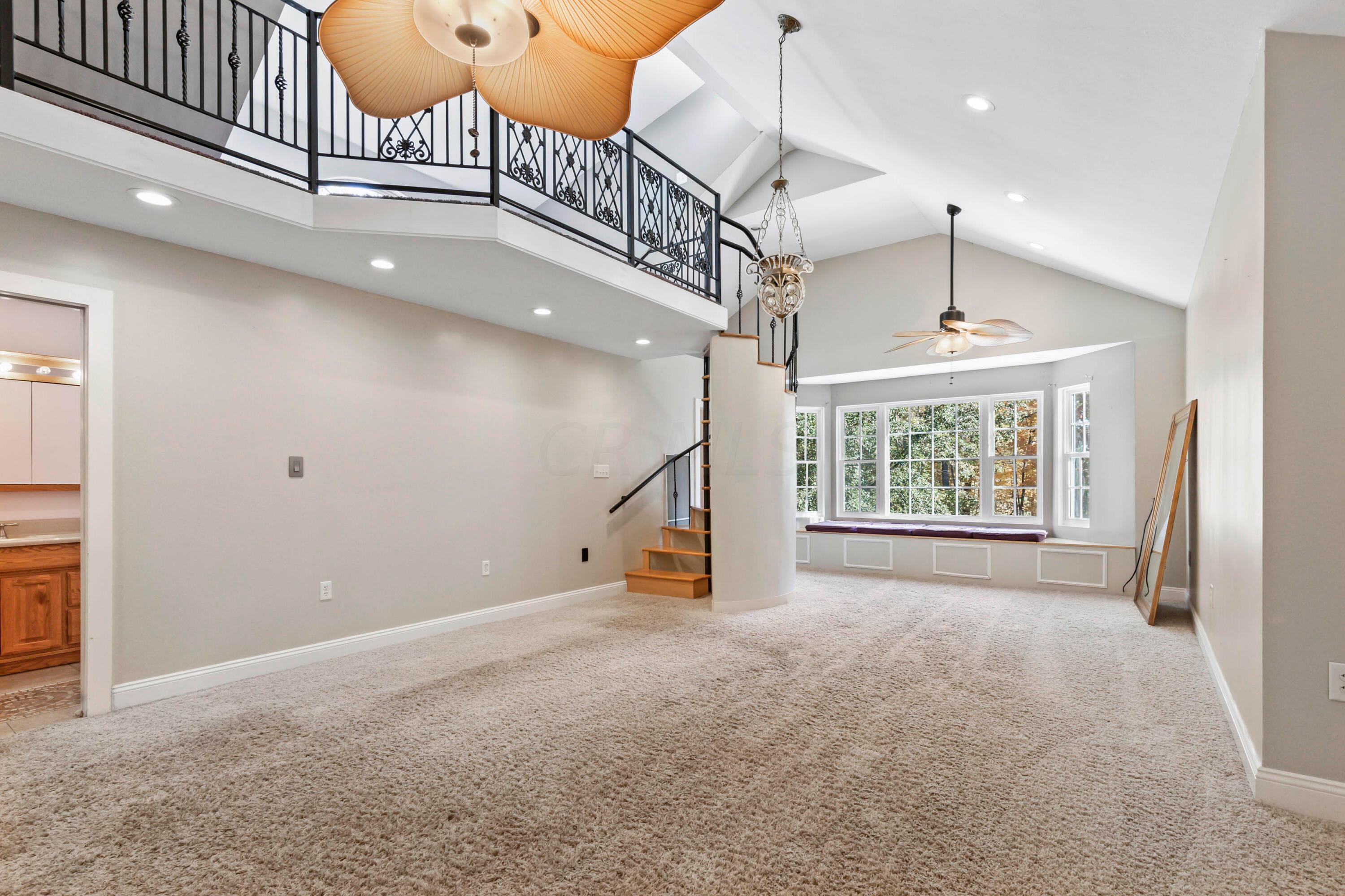 9495 Kilbourne Road Sunbury, OH 43074 - Photo 54 of 84 • Light sand carpet
• Tan painted walls
• (2) lighted ceiling fans
• Window seat
• Vaulted ceiling
• Can lighting
• Hanging lights
• Wet bar with mini refrigerator
& cabinets
• Spiral staircase to Loft