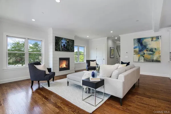 a living room with furniture fireplace and window