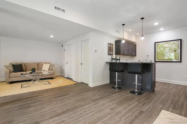 a view of a workspace with furniture and a kitchen