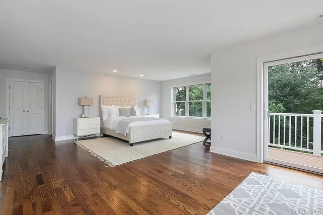 a spacious bedroom with a bed and a large window