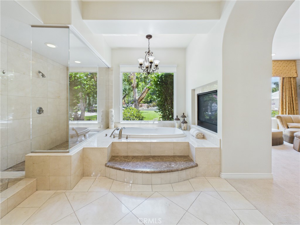 1662 Cherokee Road Corona, CA 92881 - Photo 34 of 60 Primary bathroom, dual sided fireplace and walk-in shower.