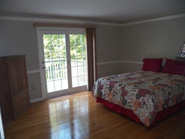 54 Juniper Road Ashburnham, MA 01430 - Photo 12 of 26 a large bed sitting in a bedroom next to a window