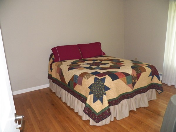 54 Juniper Road Ashburnham, MA 01430 - Photo 14 of 26 a bedroom with a bed and wooden floor