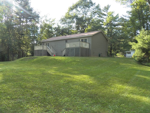 54 Juniper Road Ashburnham, MA 01430 - Photo 3 of 26 a view of a backyard with a house