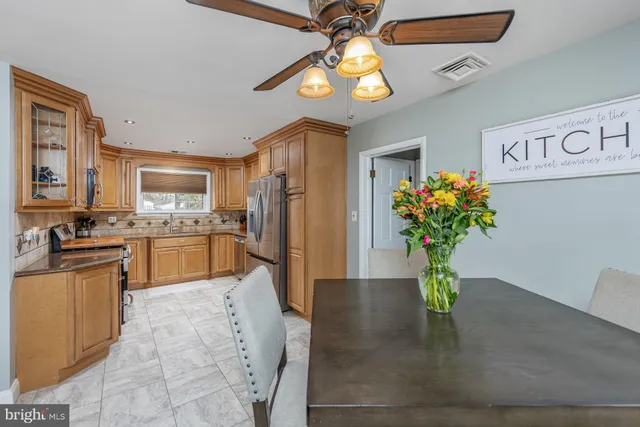 a kitchen with granite countertop stainless steel appliances and chandelier