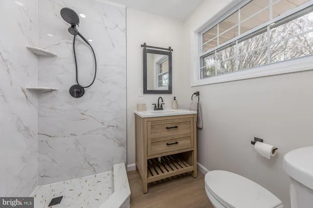 a bathroom with a toilet sink and shower