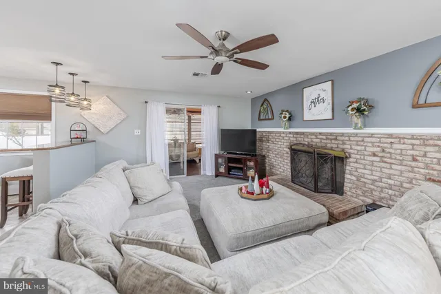 a living room with furniture a window and a fireplace