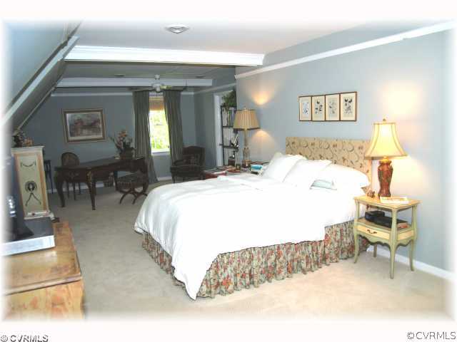 2100 Winterfield Road Midlothian, VA 23113 - Photo 6 of 12 a spacious bedroom with a bed a table and chair