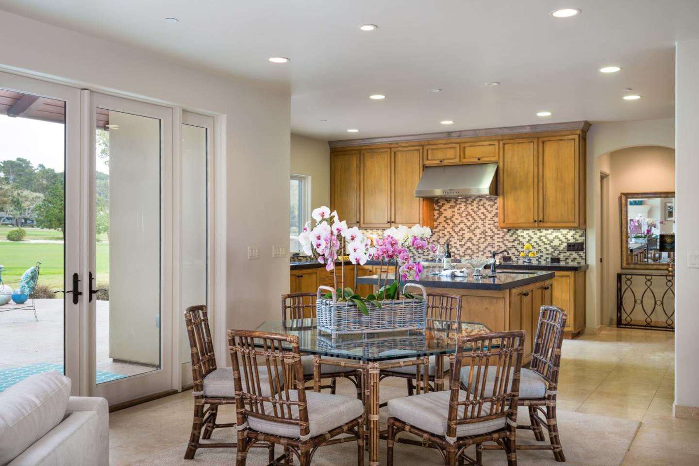 1048 Rodeo Road Pebble Beach, CA 93953 - Photo 8 of 16 a dining room filled chandelier and kitchen view