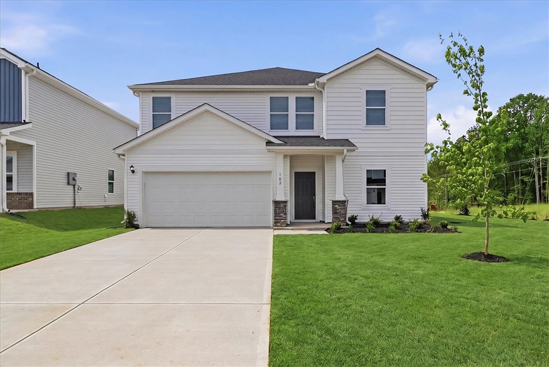 This newly built home features a classic two-story design with a welcoming front entrance.
