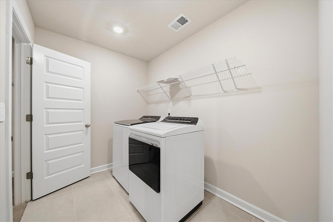102 Gibbon Way Gray Court, SC 29645 - Photo 15 of 49 This dedicated laundry area features functional appliances and convenient wall-mounted shelving.