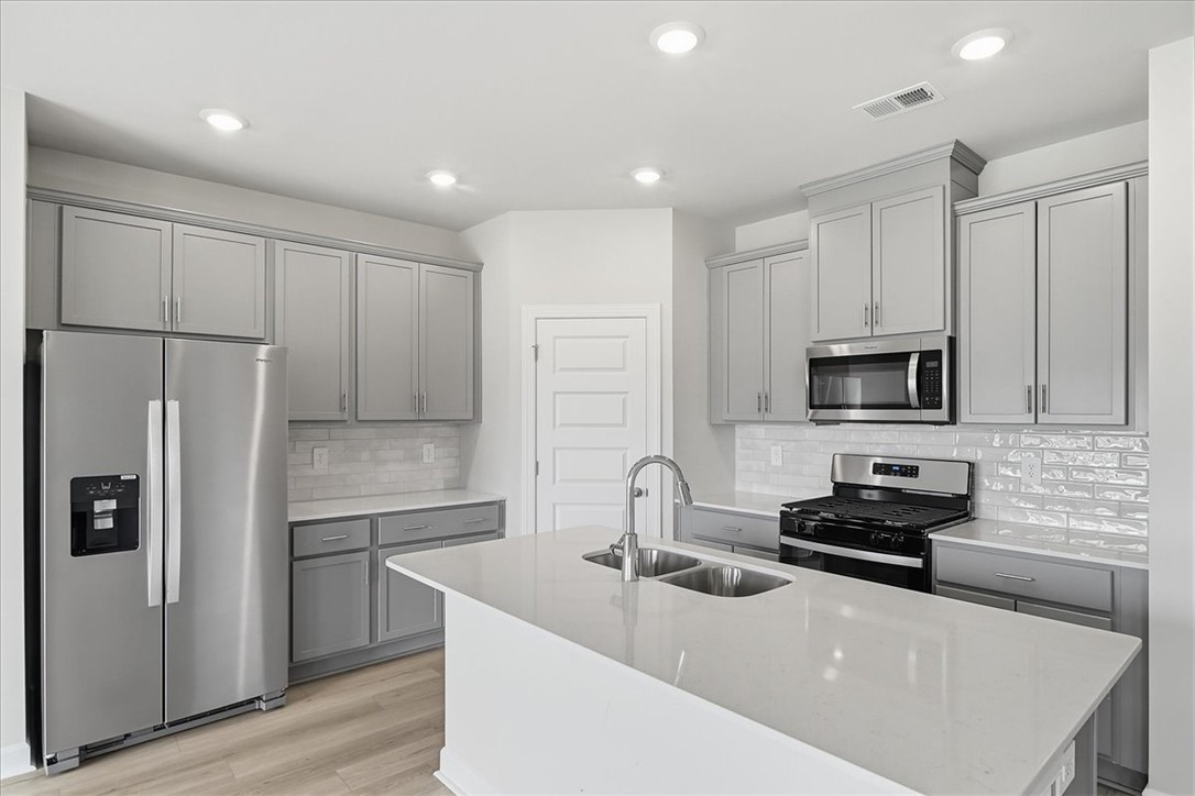 102 Gibbon Way Gray Court, SC 29645 - Photo 40 of 49 This modern kitchen features a spacious island and stainless steel appliances.