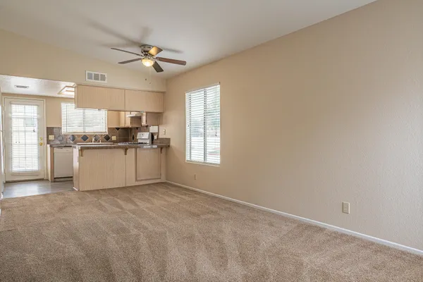 a view of a kitchen with a sink a refrigerator and window