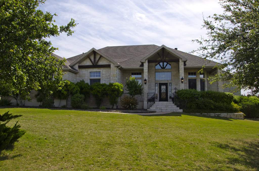 424 Tom Sawyer Road Austin, TX 78737 - Photo 1 of 1 a front view of house with yard and green space