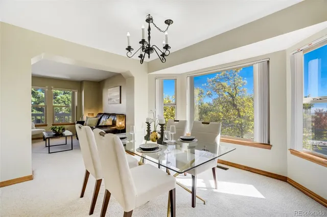 a living room with furniture a fireplace and a kitchen view