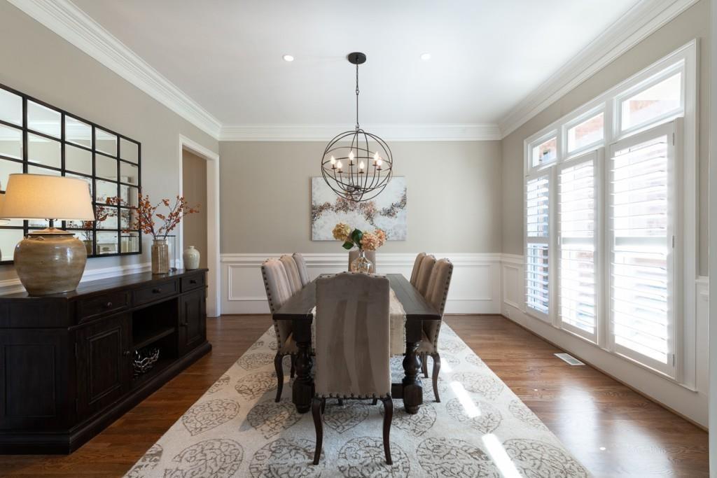 165 Autry Trail Alpharetta, GA 30022 - Photo 9 of 70 a dining room with furniture a chandelier and wooden floor