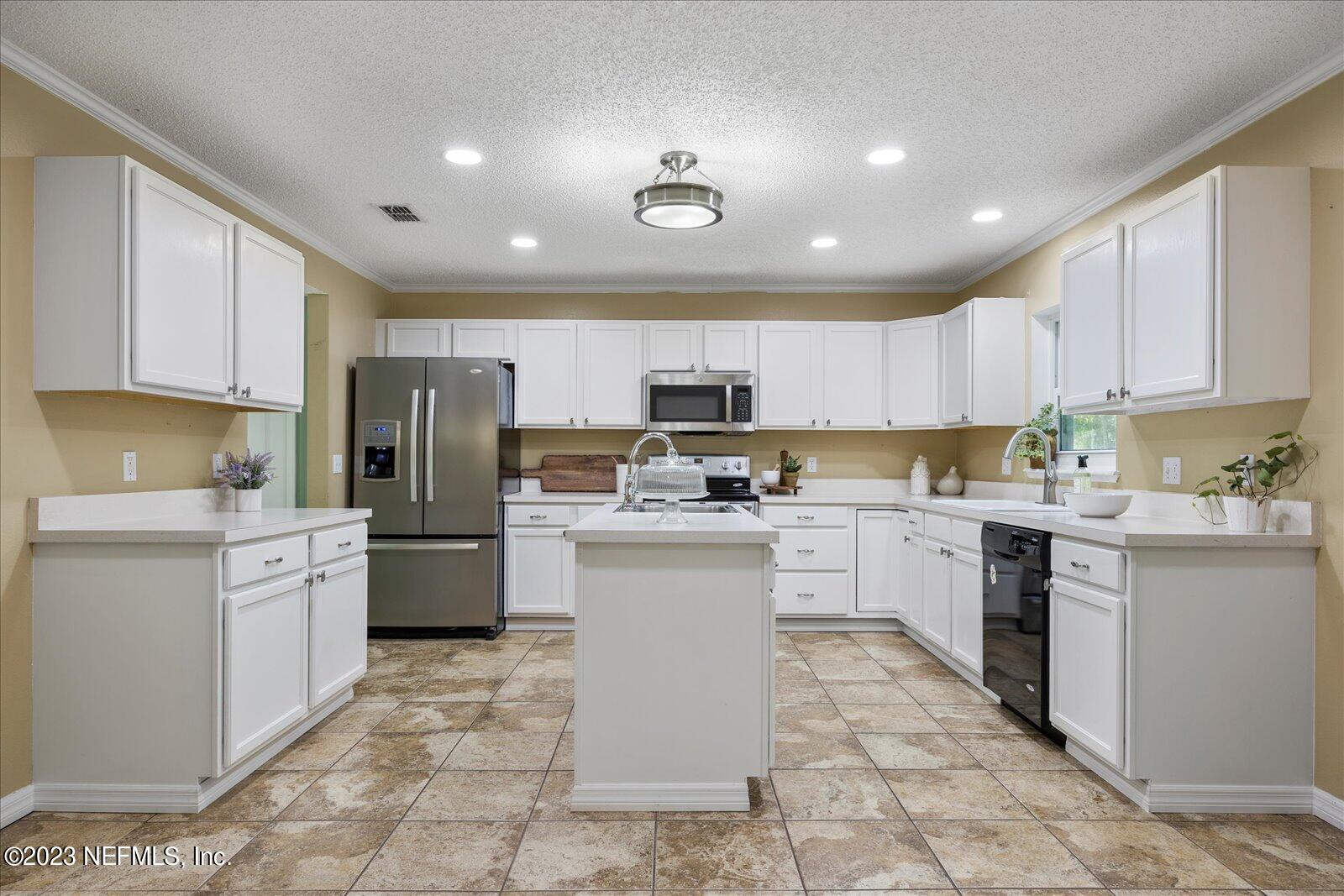 55703 Bear Run Road Callahan, FL 32011 - Photo 13 of 58 a kitchen with cabinets and stainless steel appliances