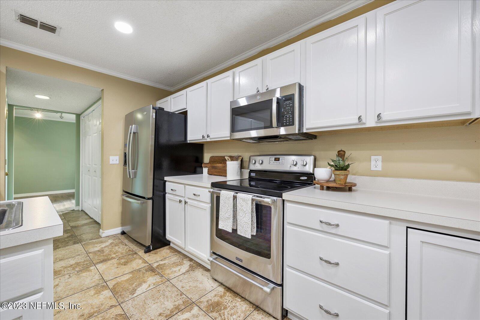 55703 Bear Run Road Callahan, FL 32011 - Photo 14 of 58 a kitchen with stainless steel appliances granite countertop a sink a stove a refrigerator and cabinets