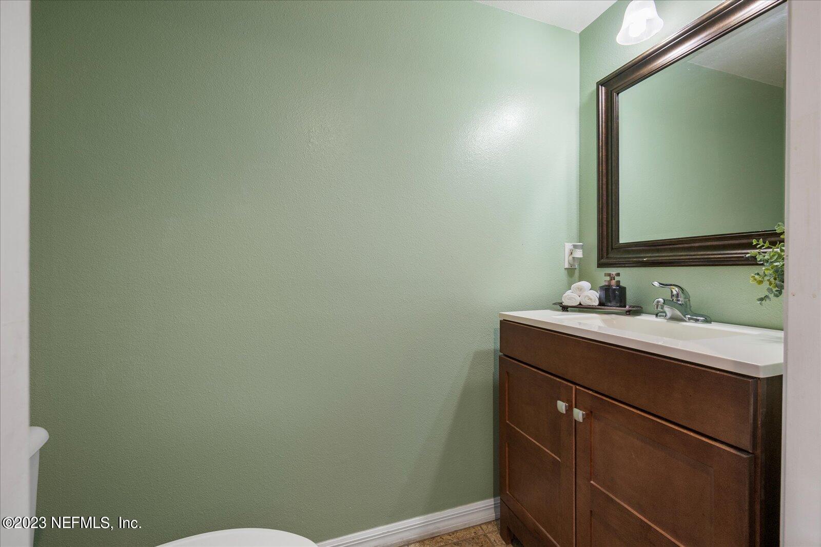 55703 Bear Run Road Callahan, FL 32011 - Photo 21 of 58 a bathroom with a sink and a mirror