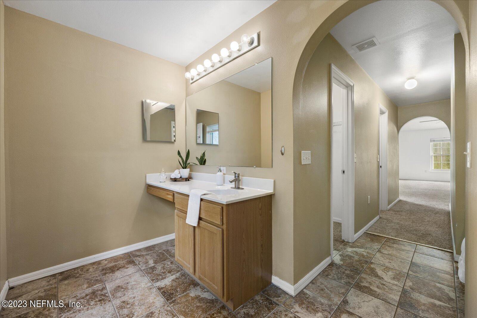 55703 Bear Run Road Callahan, FL 32011 - Photo 27 of 58 a bathroom with a sink and a mirror