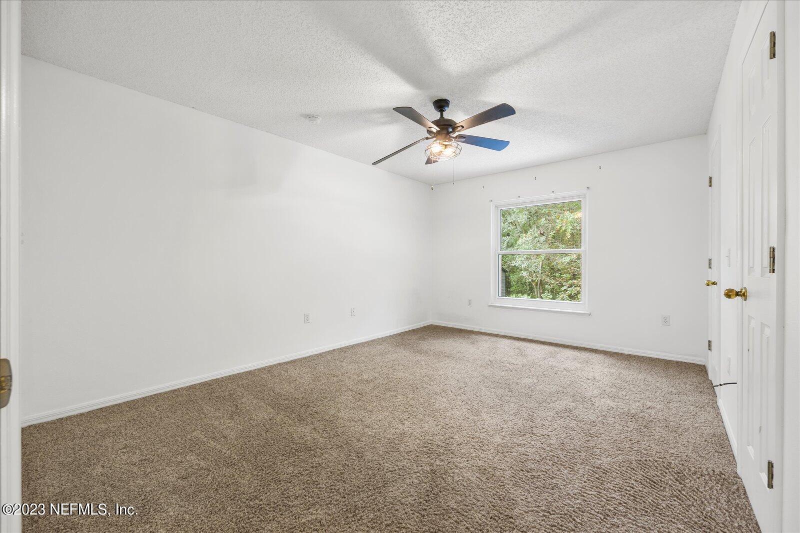 55703 Bear Run Road Callahan, FL 32011 - Photo 30 of 58 an empty room with a window and a fan