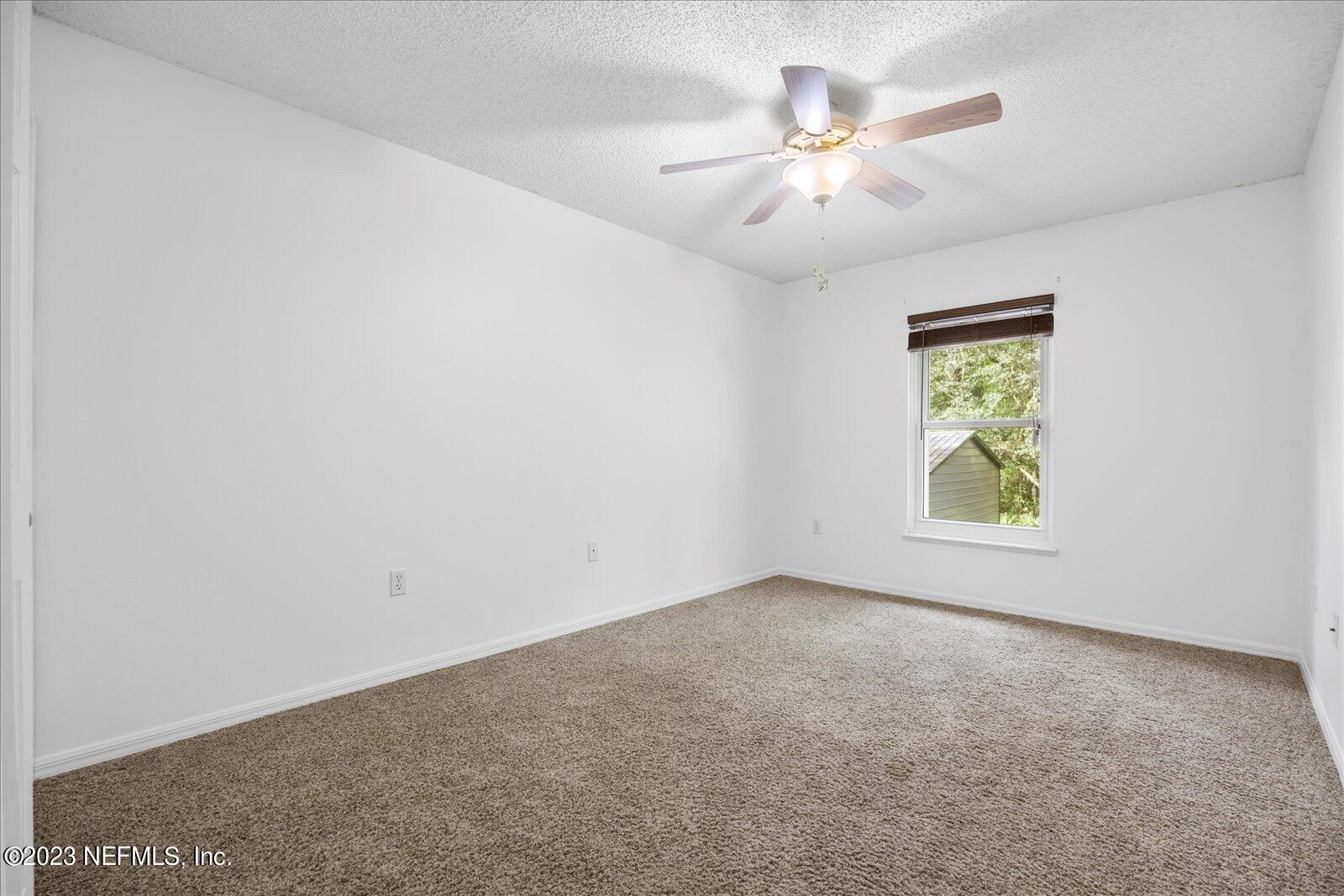 55703 Bear Run Road Callahan, FL 32011 - Photo 34 of 58 an empty room with window and ceiling fan