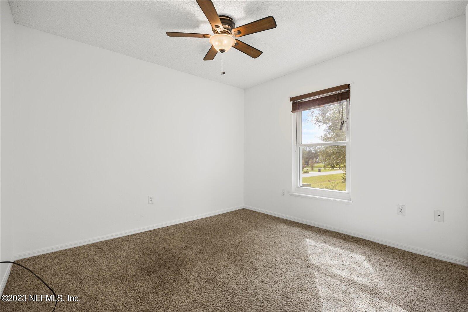 55703 Bear Run Road Callahan, FL 32011 - Photo 36 of 58 an empty room with a window and a ceiling fan
