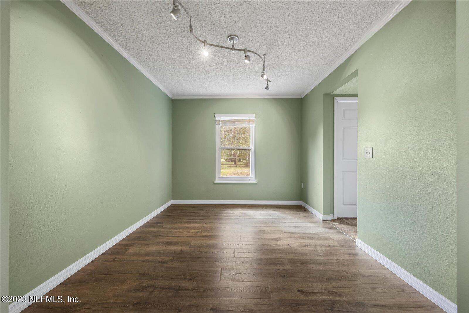 55703 Bear Run Road Callahan, FL 32011 - Photo 8 of 58 a view of an empty room with wooden floor and a window