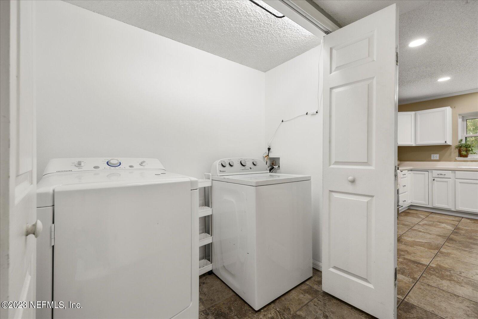 55703 Bear Run Road Callahan, FL 32011 - Photo 10 of 58 a utility room with cabinets washer and dryer