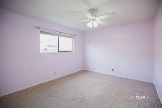 1025 Scott Street Ridgecrest, CA 93555 - Photo 19 of 29 an empty room with a fan & a window