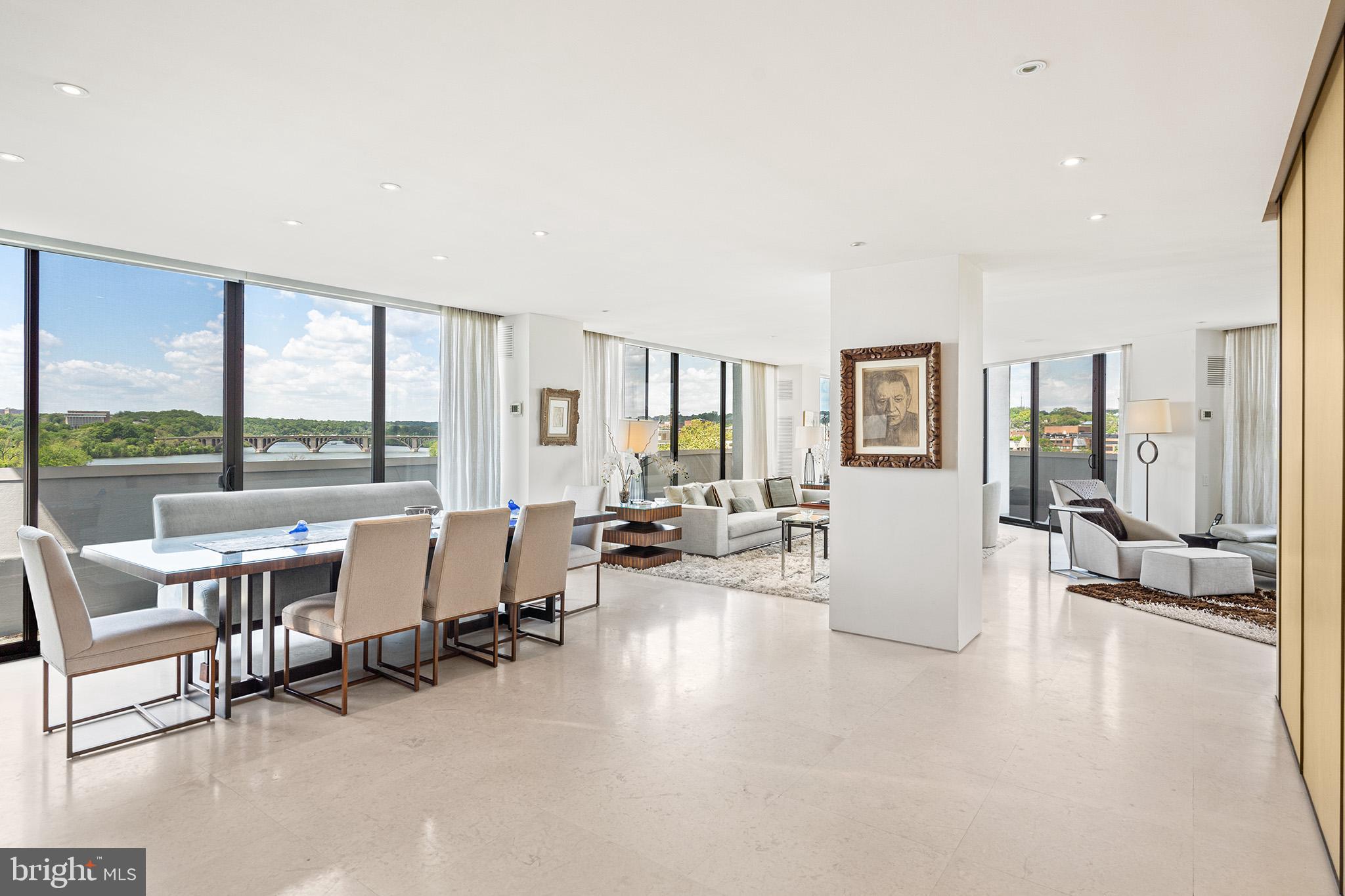 a living room with furniture and large windows
