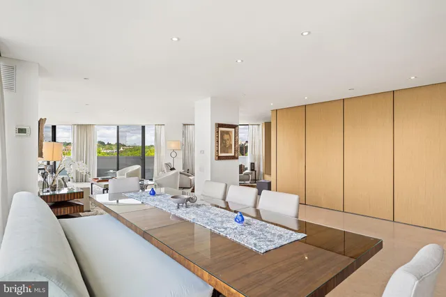 a living room with furniture large window and a table