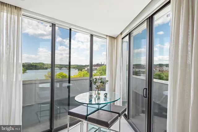 a view of a room with a furniture and floor to ceiling window