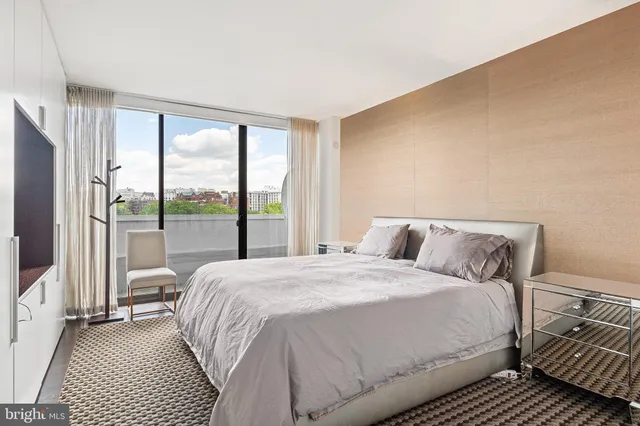 a bedroom with a bed and a large window