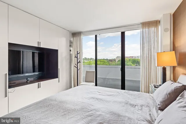 a bedroom with a large bed and a large window