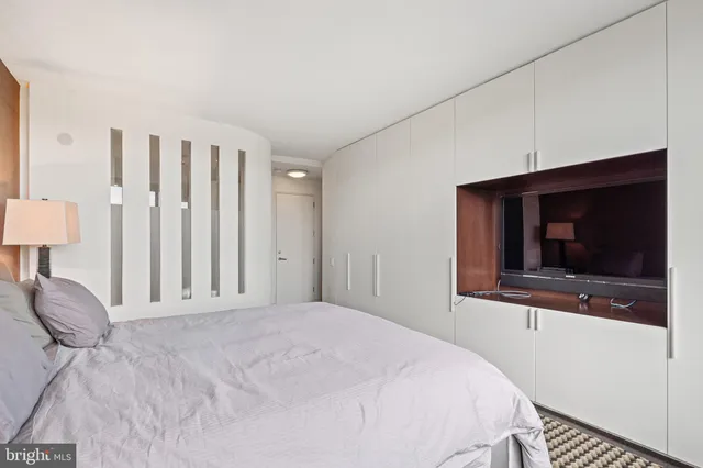a bedroom with a bed and a flat screen tv