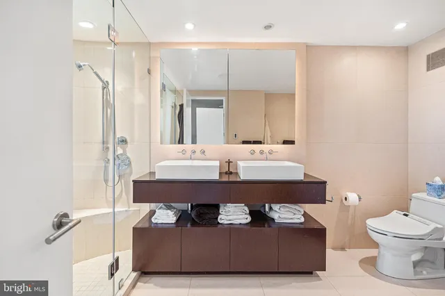 a bathroom with a sink a toilet and a mirror