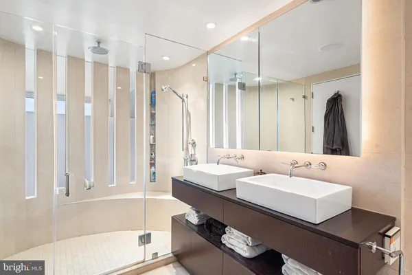 a bathroom with a tub sink and mirror