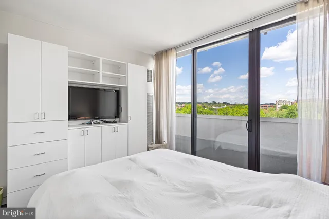 a bedroom with a bed and a television